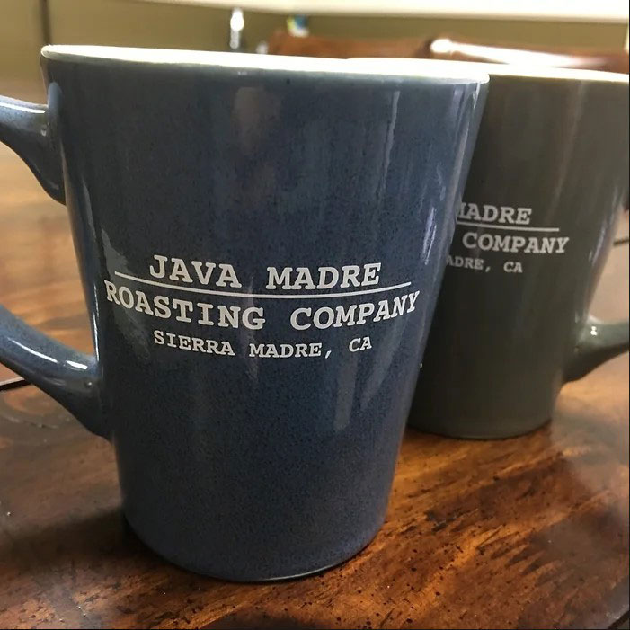Blue and brown coffee mugs with Java Madre Roasting company Logo printed on it.