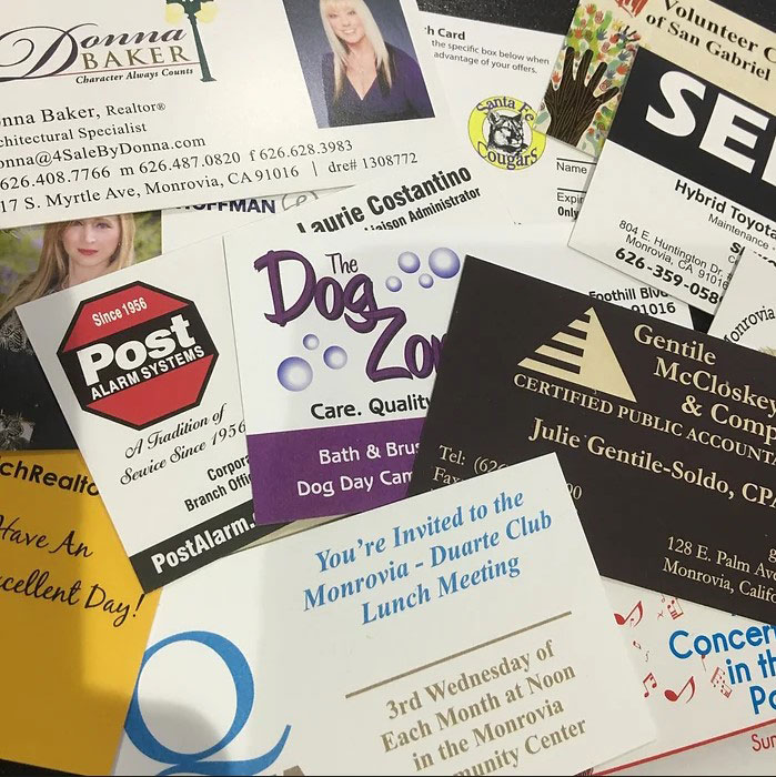 Collage of business cards on a table.