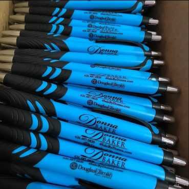 Blue and black pens with a business logo.